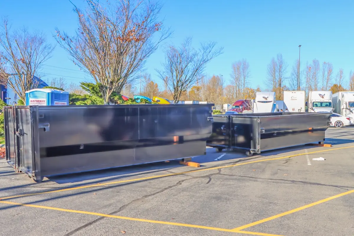 Professional dumpster rental service with roll-off container on residential driveway in Hopkinton